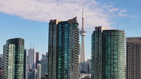 drone flying through the buildings of downtown toronto with cn tower in view