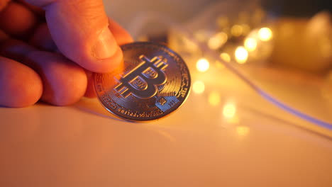 holding a bitcoin in the hand