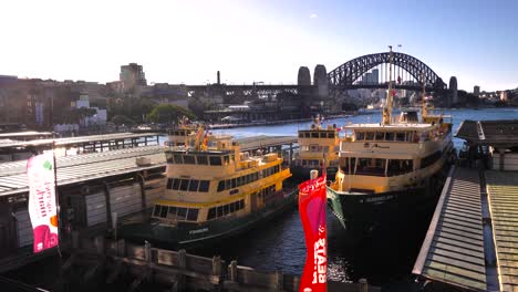 sydney ferries at circular quay with harbour bridge in the background