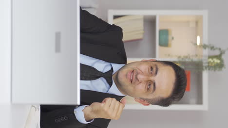 Vertical-video-of-Home-office-worker-man-looking-with-satisfied-expression.