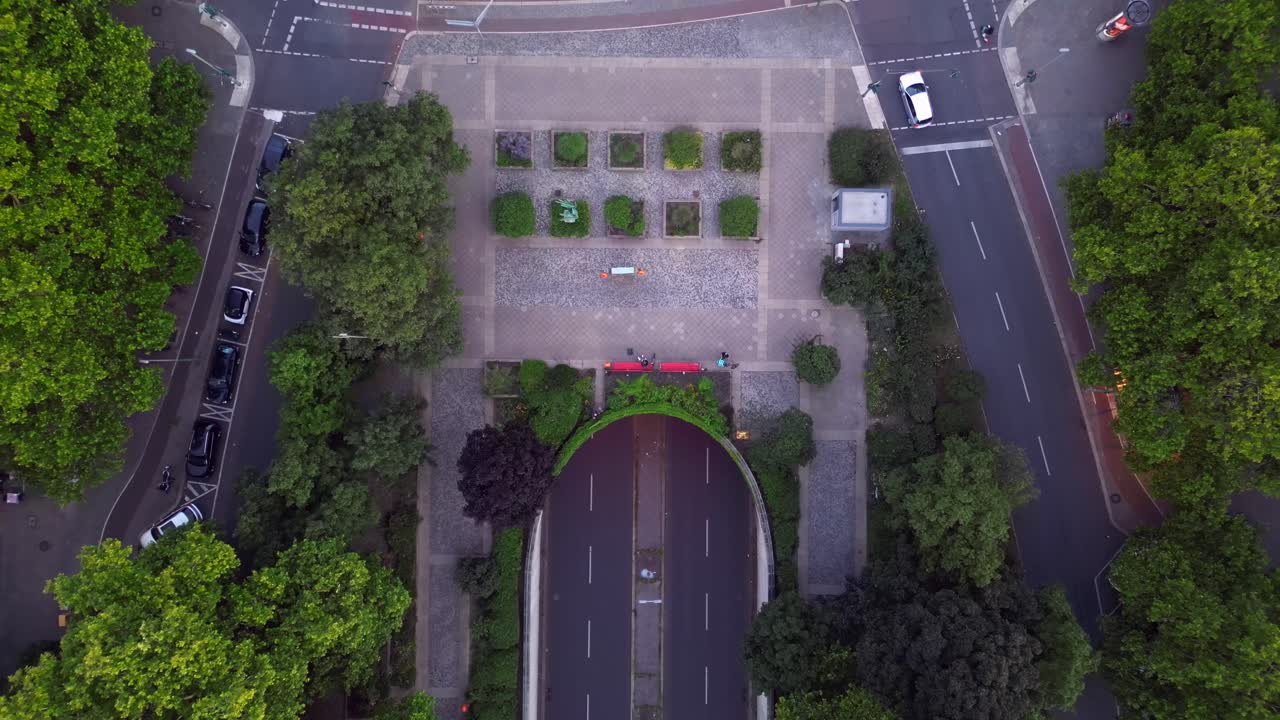 Aerial top-down view of a city park, urban square, and a road tunnel
