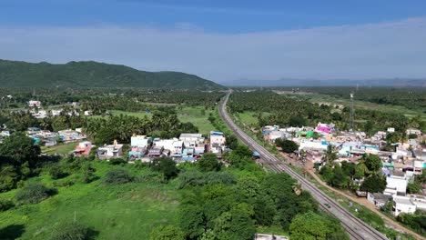 Aerial-shot-of-railway-track-in-the-middle-of-village