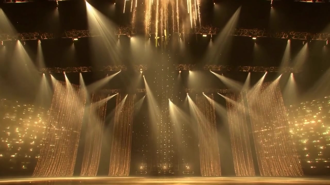 Empty Stage with Golden Lighting and Sparkling Curtains