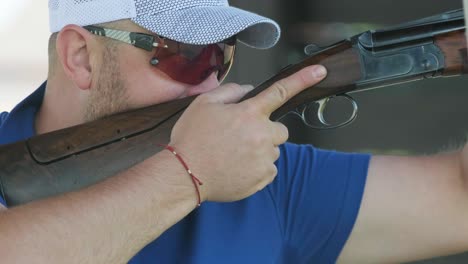 sportsman shoots from a double-barreled shotgun, a sports field for a shooting test is shooting at flying skeet