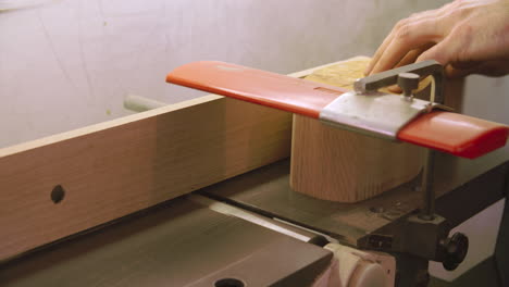 bespoke shoemaker planing wooden last for shoe using jigsaw