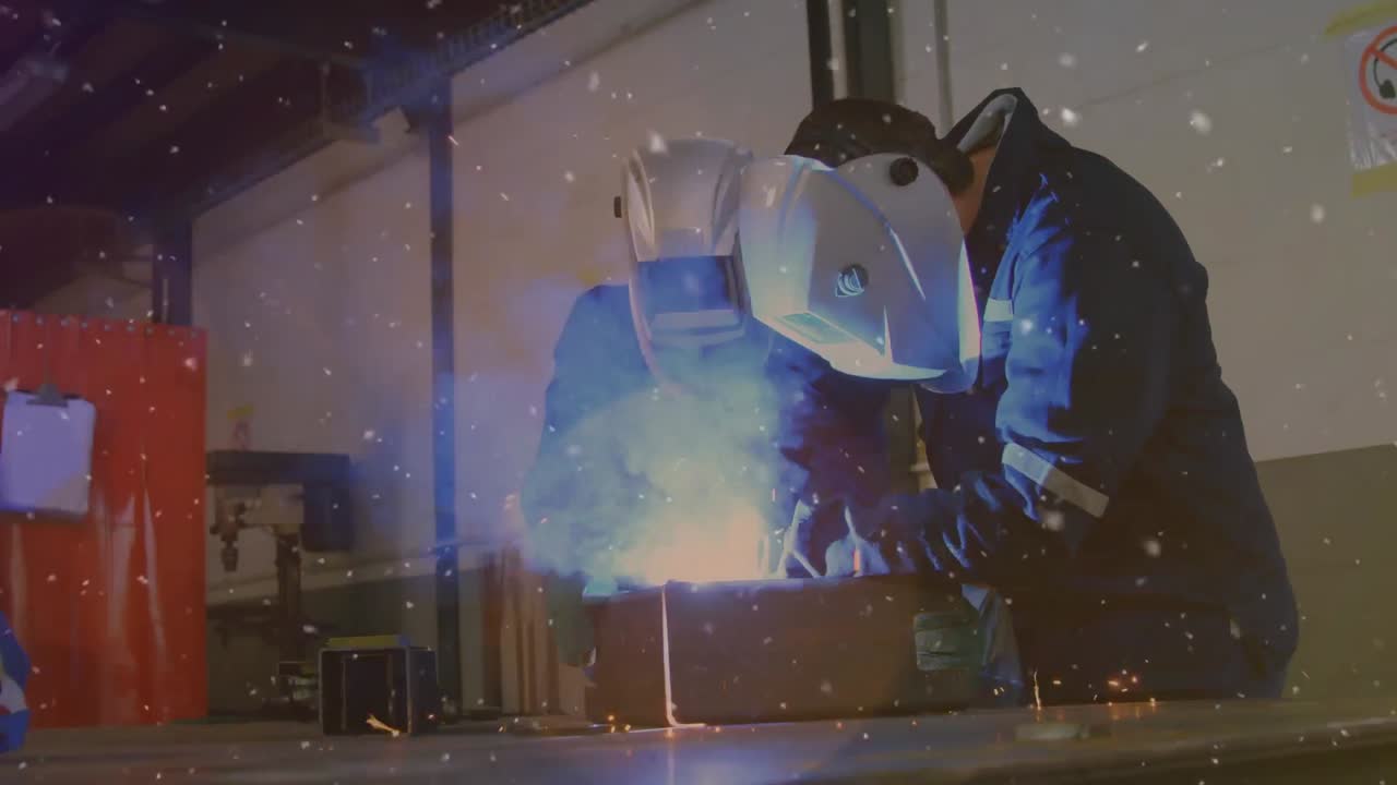 Animation of glowing spots over male engineers welding