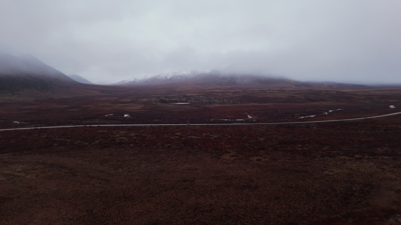 Dempster Highway And Surrounding Mountains On A Misty Day In Yukon, Canada - Drone Shot