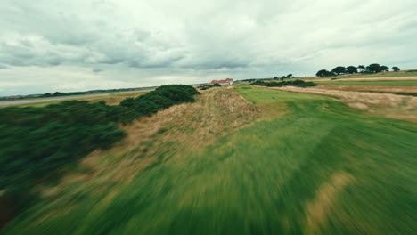 fpv drone flyover ireland links golf course par five, speed through tall grass, bunkers and green fairways