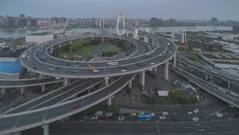 motion time lapse of traffic on nanpu bridge spiral road day to night , shanghai, china in 4k video