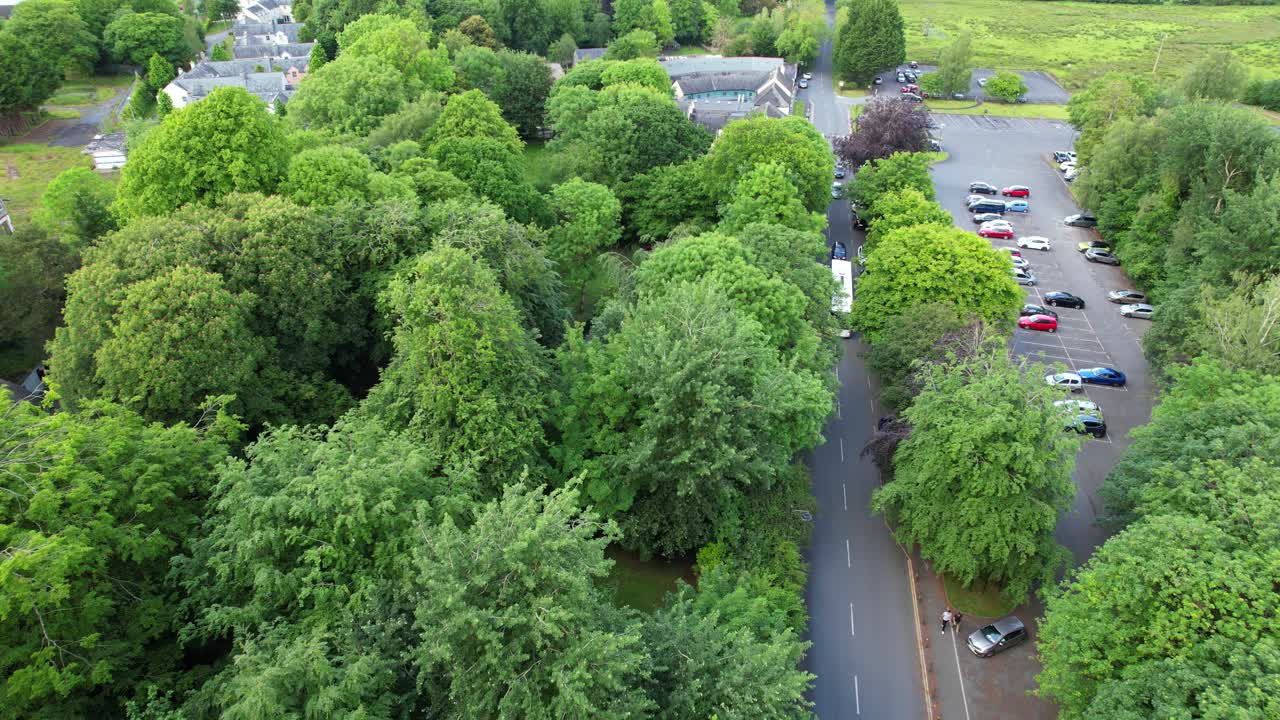 Folk Park aerial view while vehicles drive in street and people walk, Ireland