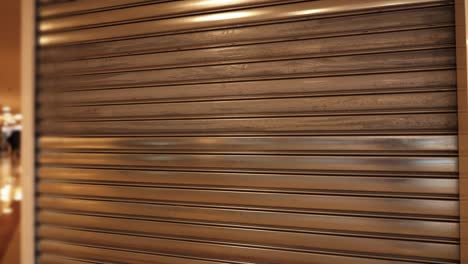 motion to large store closed with metal shutters in mall