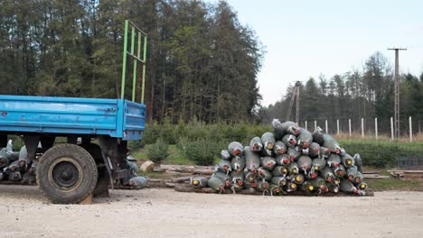 wrapped christmas trees near a blue truck