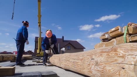 log house construction with crane