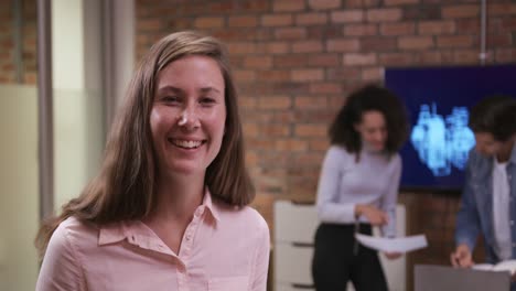 Creative-businesswoman-smiling-in-modern-office