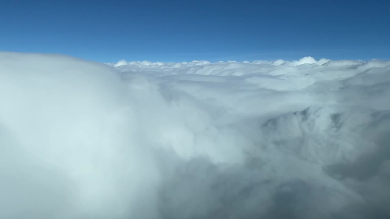 flying over the white clouds with a blue sky