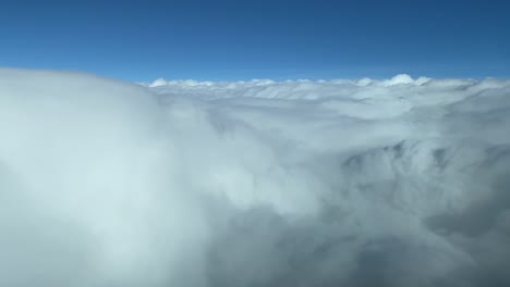 flying over the white clouds with a blue sky