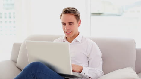 Beautiful-young-man-working-on-his-laptop