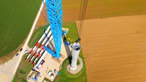 large crane on a wind turbine construction site in austria - drone shot