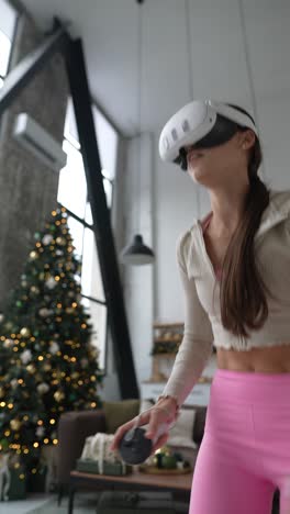 mujer haciendo ejercicio con auriculares vr en casa cerca del árbol de navidad