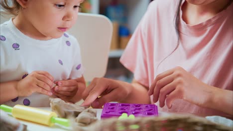 engaging moments: a mother and child bonding over creative play activities with modeling clay in a colorful indoor setting
