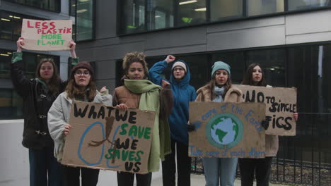 multicultural group of young female activists with banners protesting against climate change 2