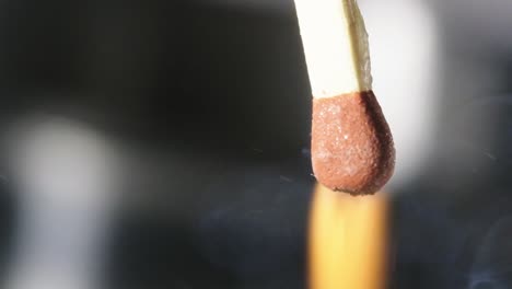 slow motion shot follow match head igniting after friction in matchbox, macro shot