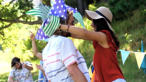 hipster couple dancing with a garland