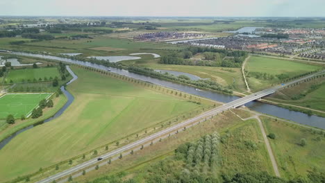 Aerial-drone-shot-of-flying-up-revealing-of-the-road-and-suburban-in-the-Netherlands