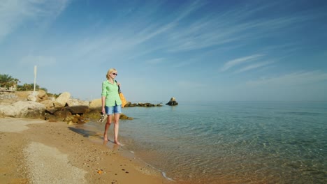 Steadicam-Shot-Woman-Walking-Along-The-Surf-Line-At-Amanecer