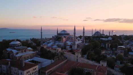 Hagia-Sophia-Grand-Mosque-During-Golden-Hour-Sunset-In-Istanbul-Turkey-With-Iconic-Blue-Mosque-In-Background---drone-pullback