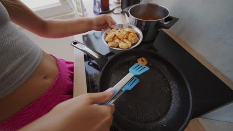 person preparing shrimp in a kitchen