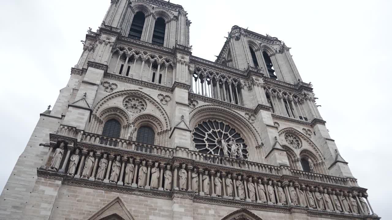 A slow pan of the Notre Dame Church in the center of Paris France midday in winter.