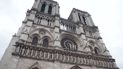 a slow pan of the notre dame church in the center of paris france midday in winter.