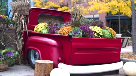 flowers in the back of a red pickup truck