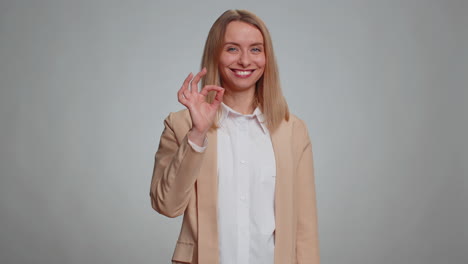 woman looking approvingly, showing ok approve feedback gesture like sign positive something good