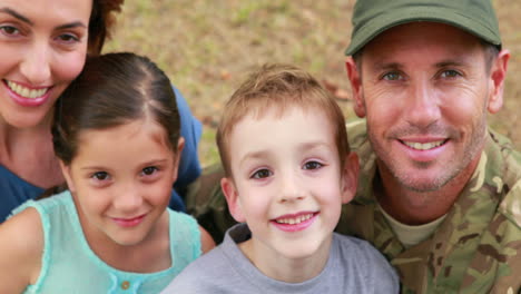 Happy-family-looking-at-camera-