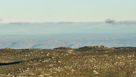 mountain ridge view of wind turbines below, serra da estrela