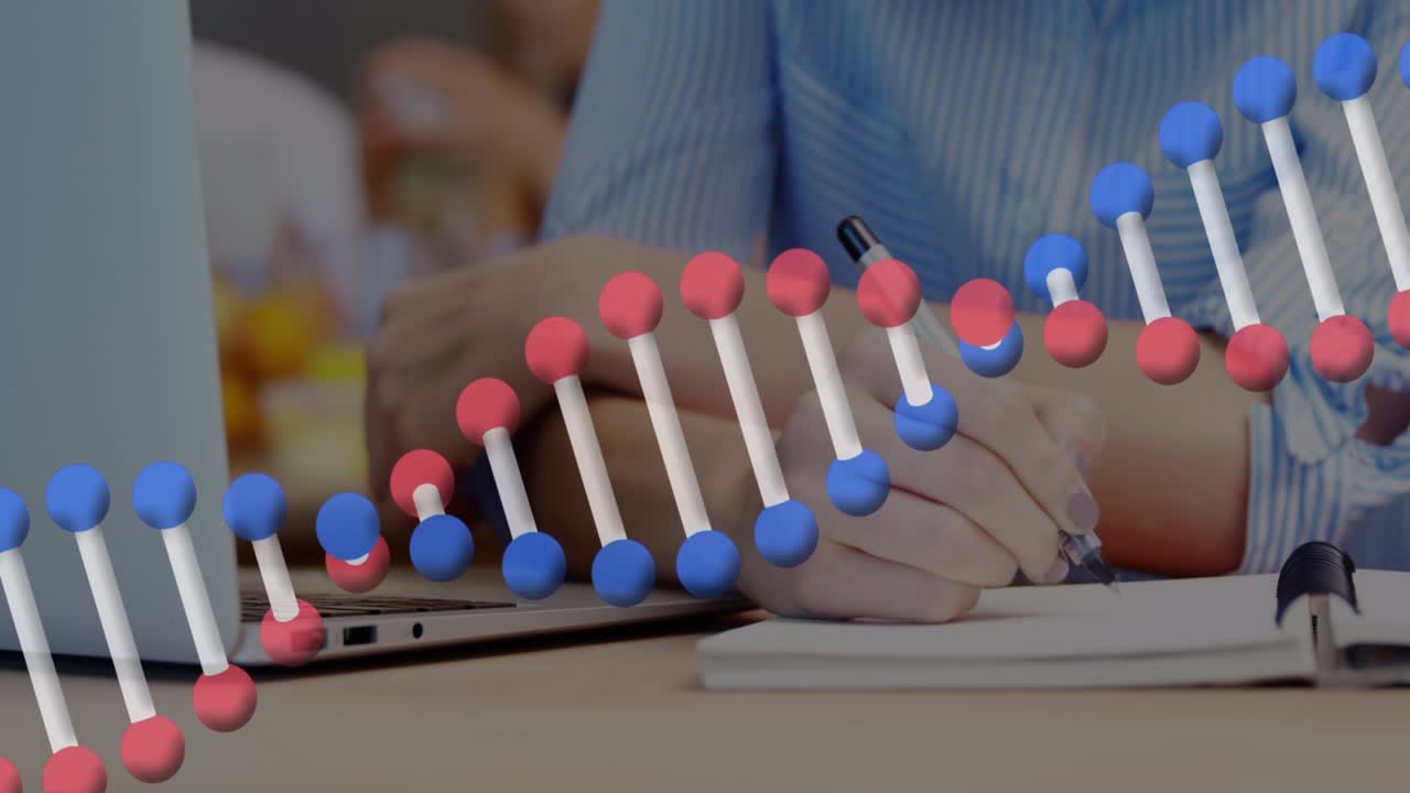 Animation of dna strand spinning over businesswoman using laptop