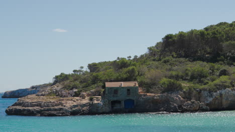 secluded coastal house on rocky shores of cala mondrago, mallorca