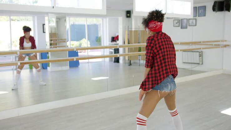 Female dancer practices her moves in studio