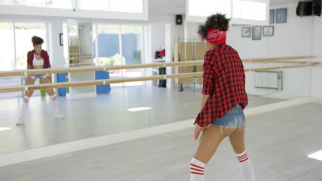 female dancer practices her moves in studio