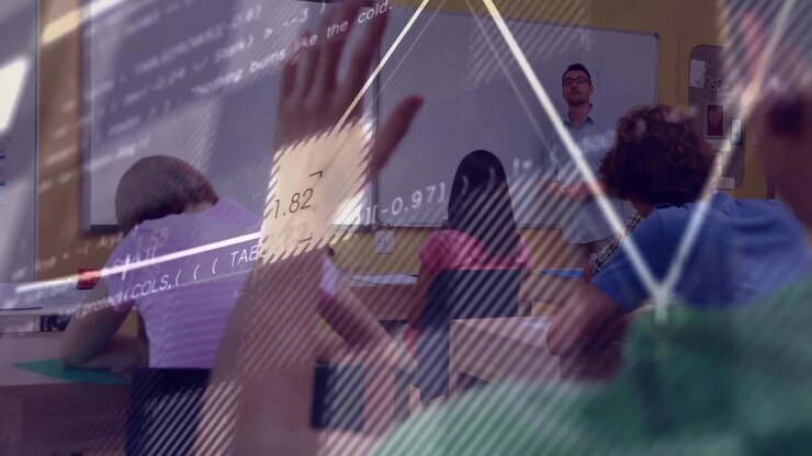 Teacher standing gesturing in edtech classroom, with projected code overlay flowing across desks