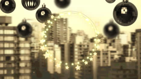 yellow star shaped fairy lights and hanging bauble decorations against aerial view of cityscape