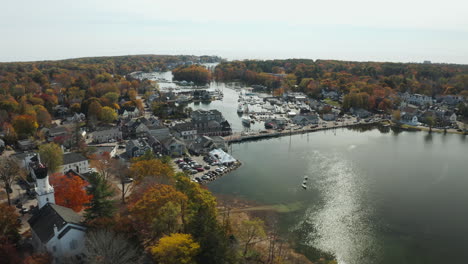 Autumn aerial scenery, calm river across busy town center with harbor, Kennebunkport Maine
