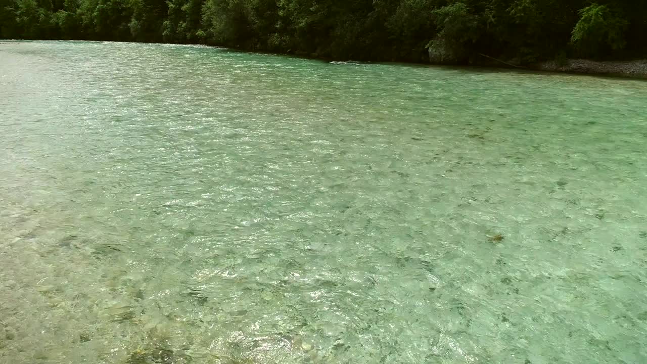 Aerial view of turquoise water going down the river at Soca river, Slovenia.