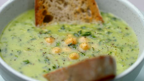 bowl of creamy chickpea and vegetable soup rotating