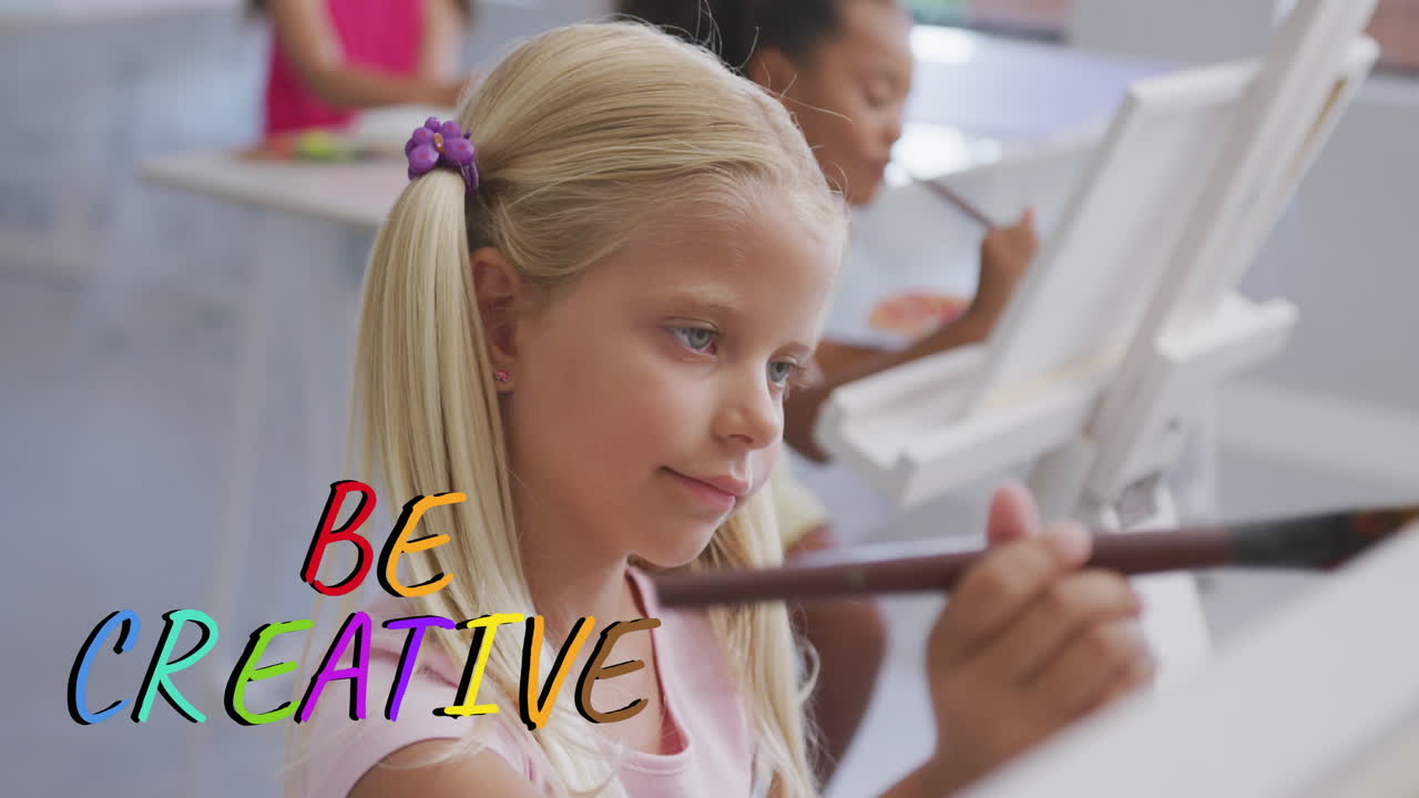Animation of be creative text in multi colours over happy caucasian schoolgirl painting in art class