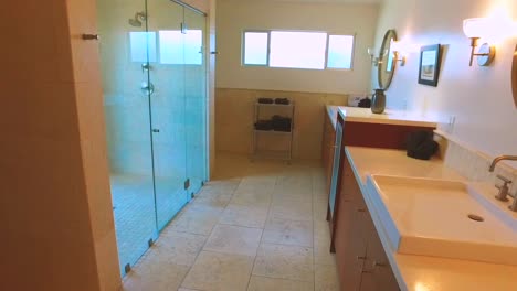 pan shot, inside a modern bathroom, in a palm springs house, in california, usa