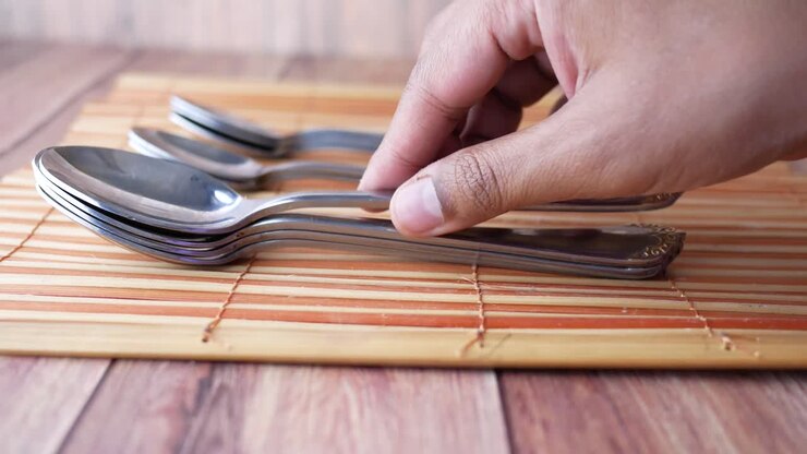 Stacked Spoons on Bamboo Placemat