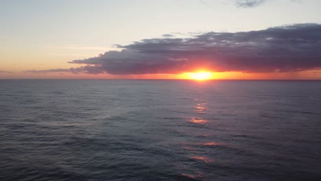 drone shot pan rise over reef and ocean to reveal orange morning sunrise at blue bay beach the entrance central coast nsw australia 3840x2160 4k
